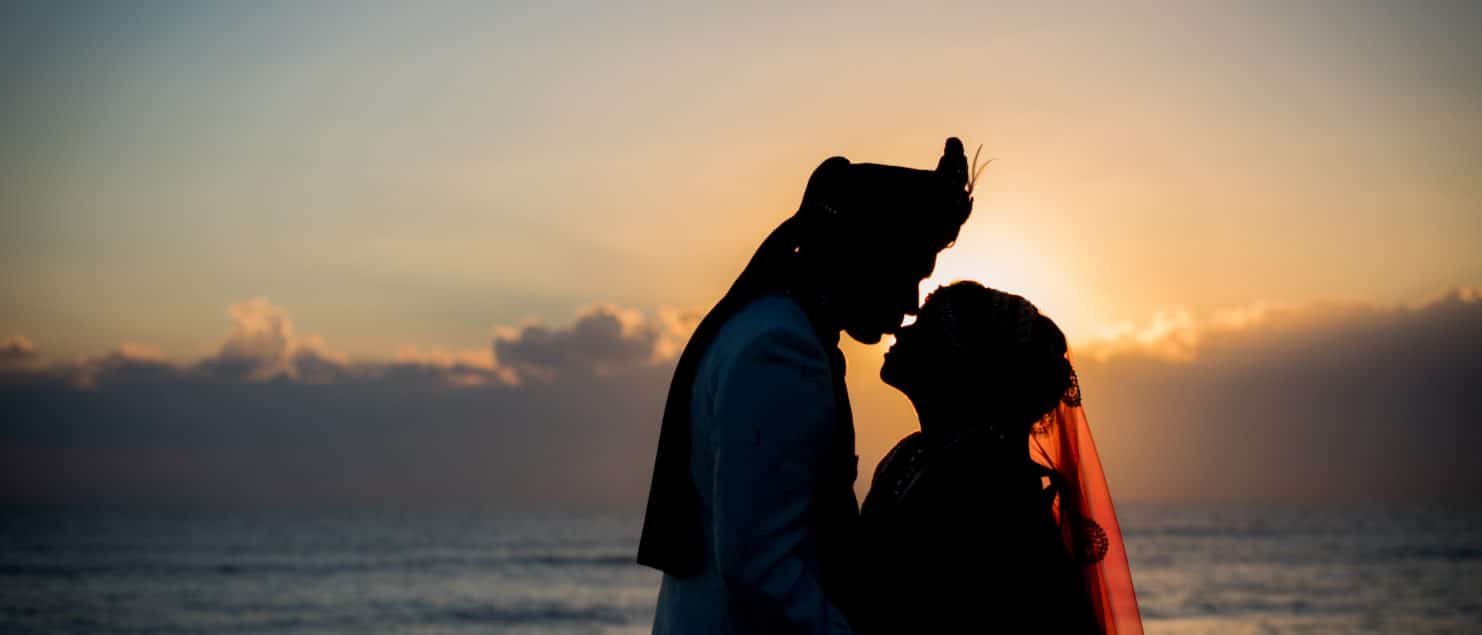 wedding portrait at the beach at sunrise