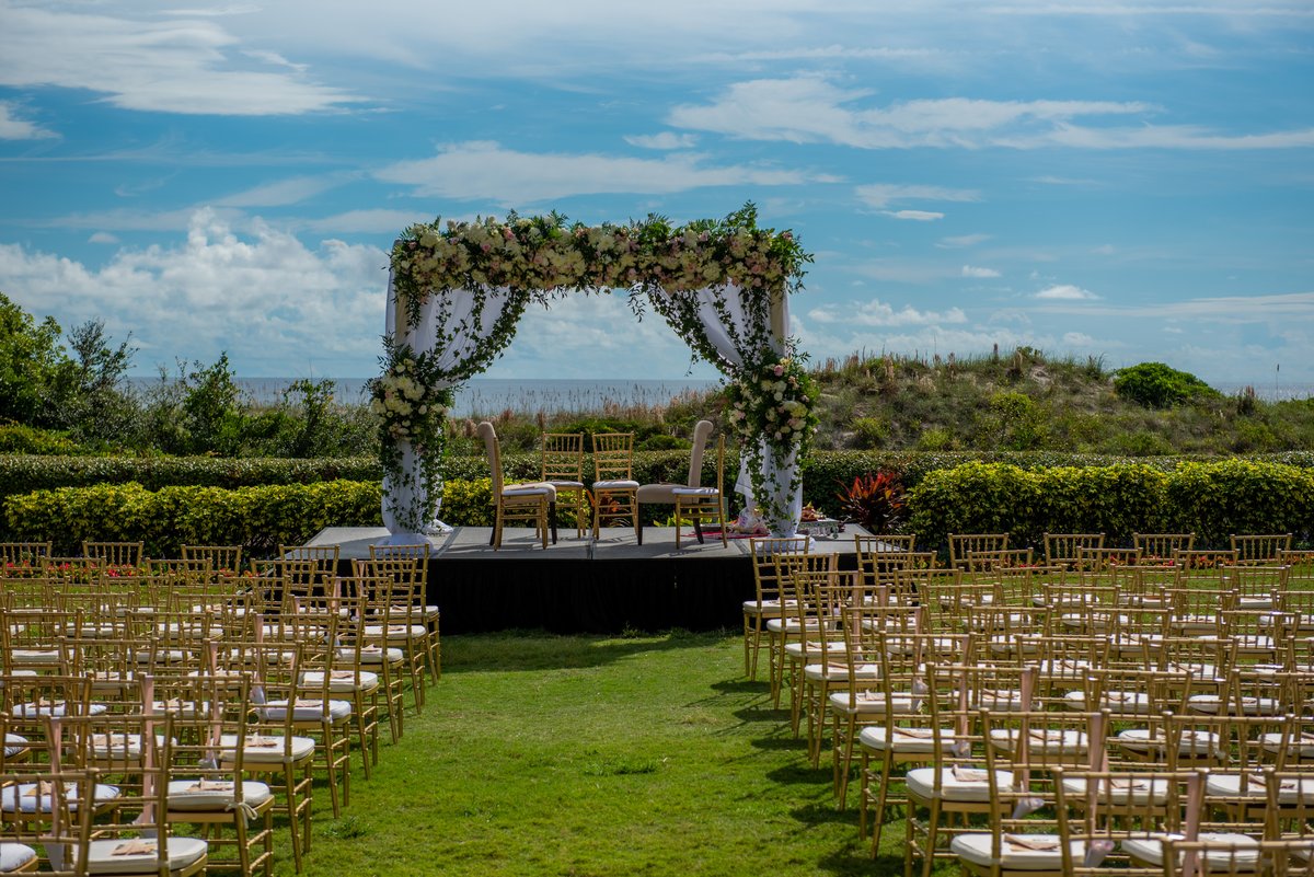 Indian wedding mandap on the beach with flowers everywhere and the ocean behind, Ritz-Carlton Amelia Island