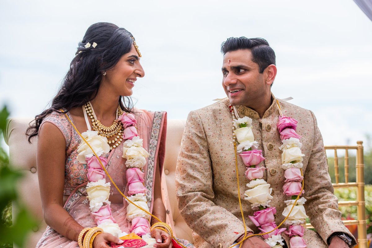 Bride and groom laughing with pure joy, Indian wedding
