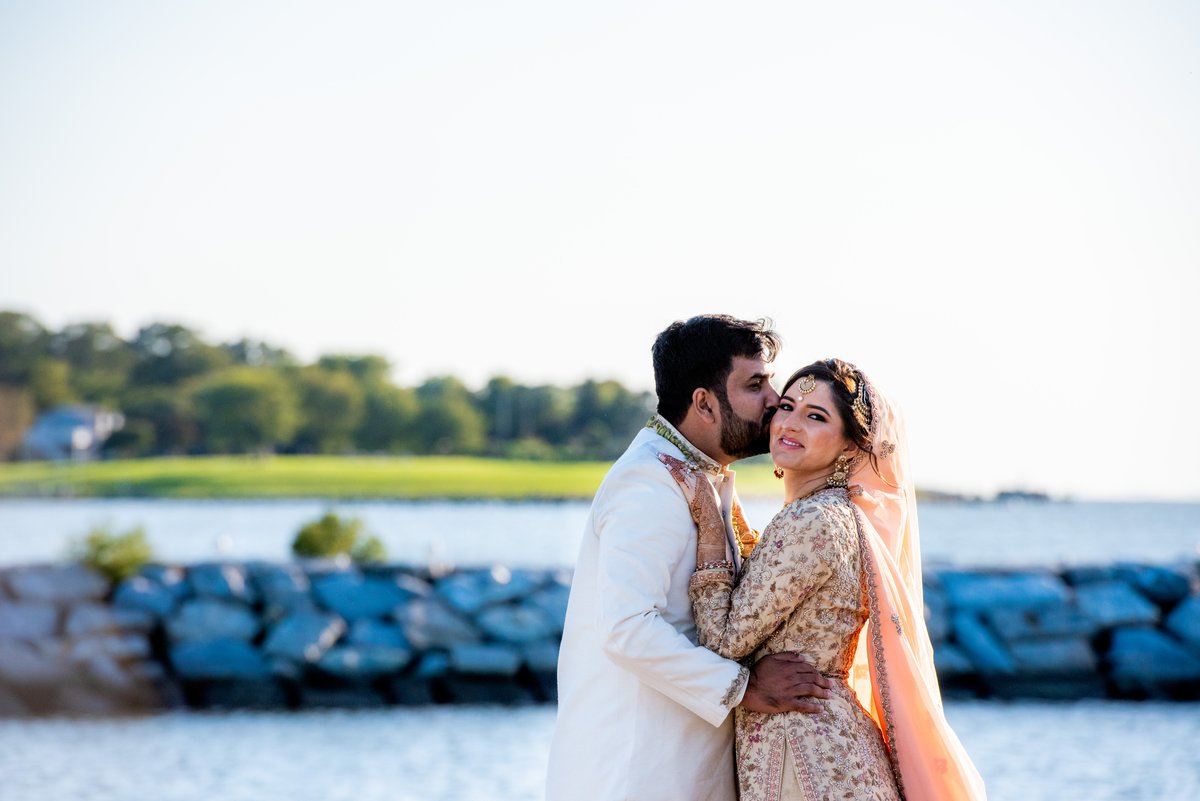 Romantic sunset portrait of Ghazal and Sirfaraz by the water at Chesapeake Bay Beach Club