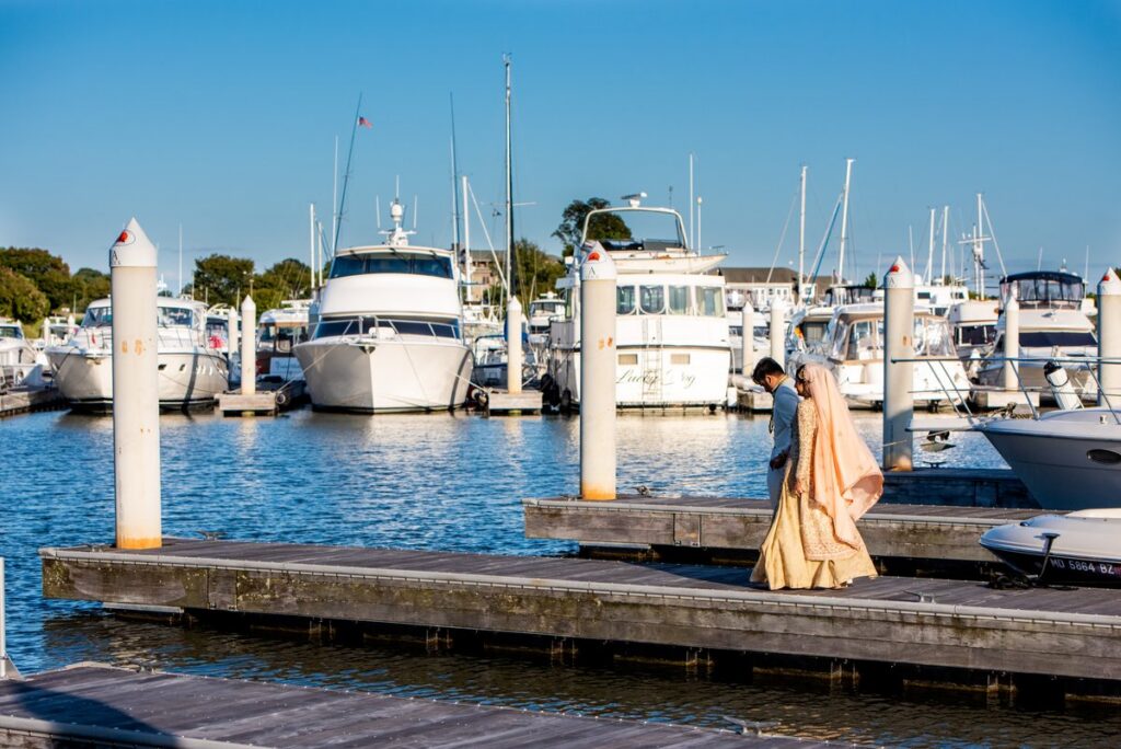 Ghazal and Sirfaraz at sunset by the water at their Chesapeake Bay Beach Club Maryland wedding