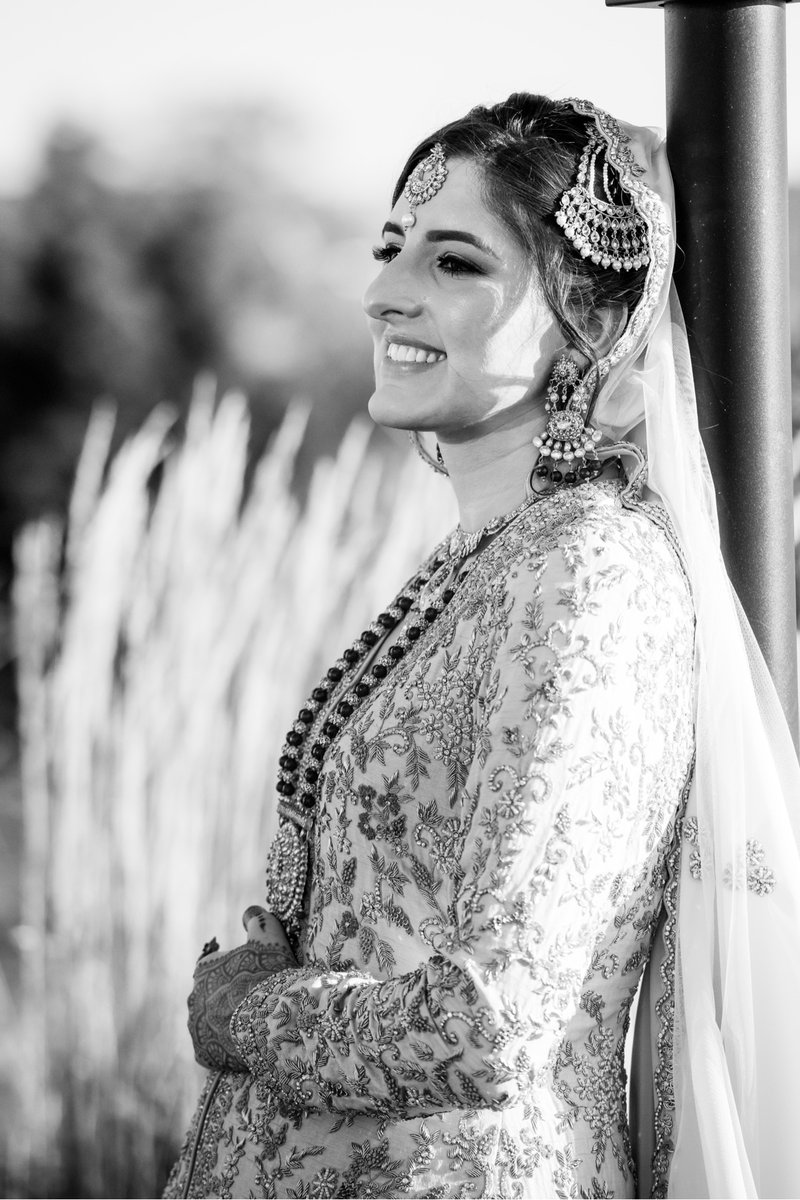 Black and white bridal portrait of a smiling Muslim bride at Chesapeake Bay Beach Club Maryland
