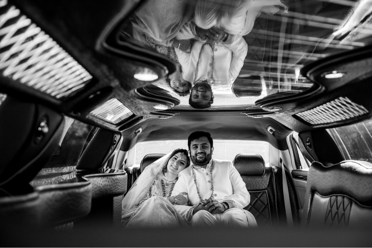 Candid reflection of smiling newlyweds in the limo ceiling after their nikkah
